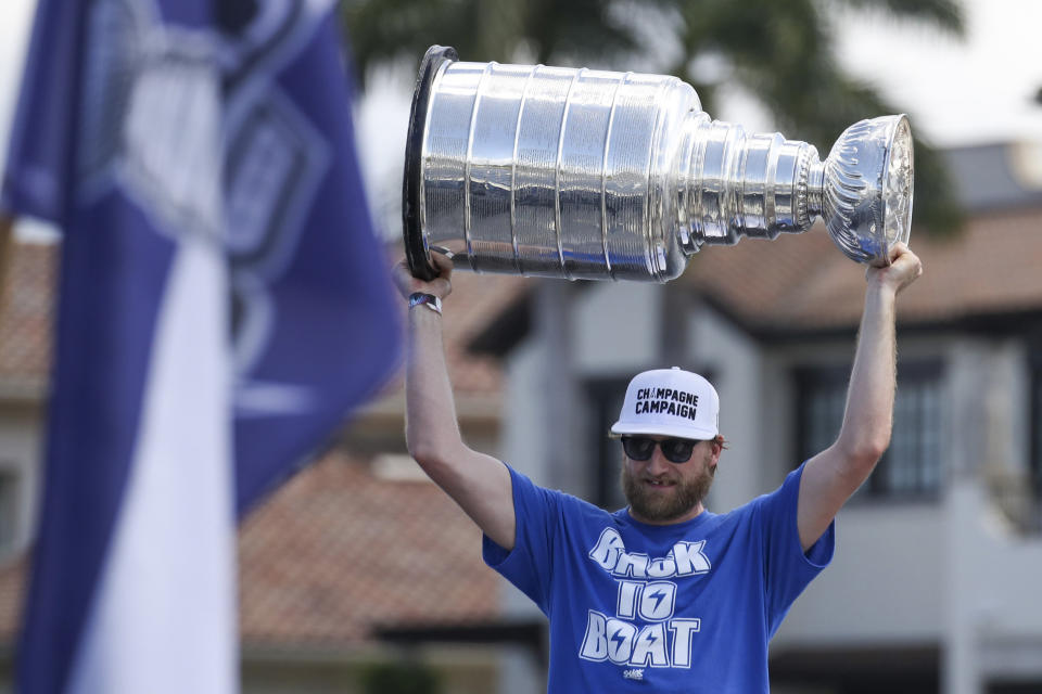 Tampa Bay Lightning center Steven Stamkos holds up the Stanley Cup as the team celebrates their Stanley Cup victory with a boat parade Monday, July 12, 2021 in Tampa, Fla. (Dirk Shadd/Tampa Bay Times via AP)