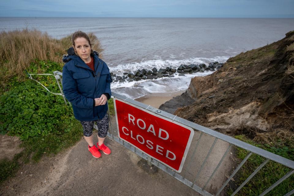 Nicola Bayless pictured where the land has now been lost to coastal erosion. (SWNS)