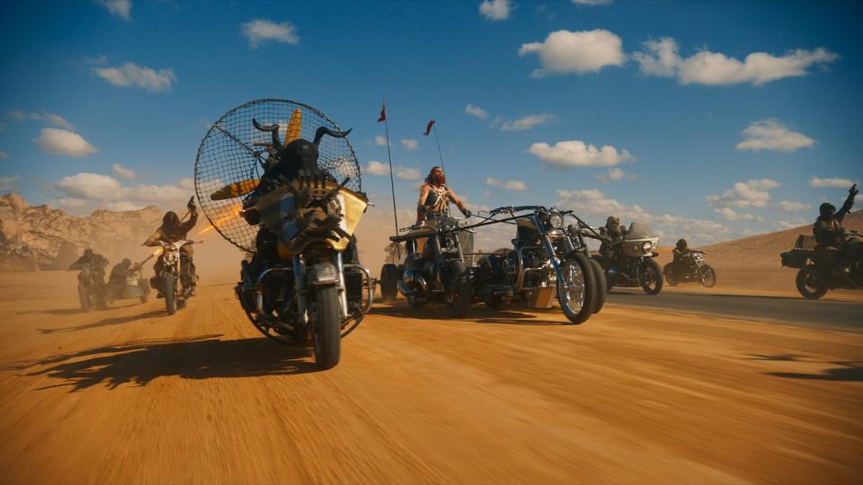 a group of motorcycles on a desert road