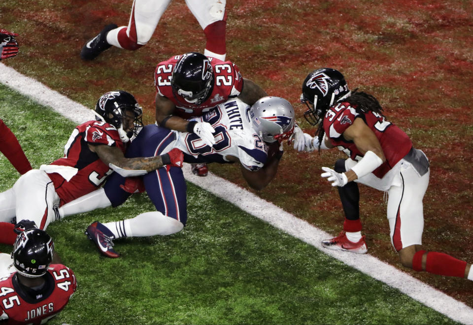 FILE - New England Patriots' James White scores the winning touchdown during overtime of the NFL Super Bowl 51 football game against the Atlanta Falcons, Sunday, Feb. 5, 2017, in Houston. James White said Thursday, Aug. 11, 2022, he is retiring from the NFL. (AP Photo/Charlie Riedel, File)
