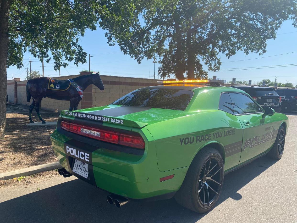 In Amarillo, Texas, a Dodge Challenger is seized by the Amarillo Police Department for illegal street racing. The back of the vehicle has a line in bold white text that reads: "This car was seized from a street racer."