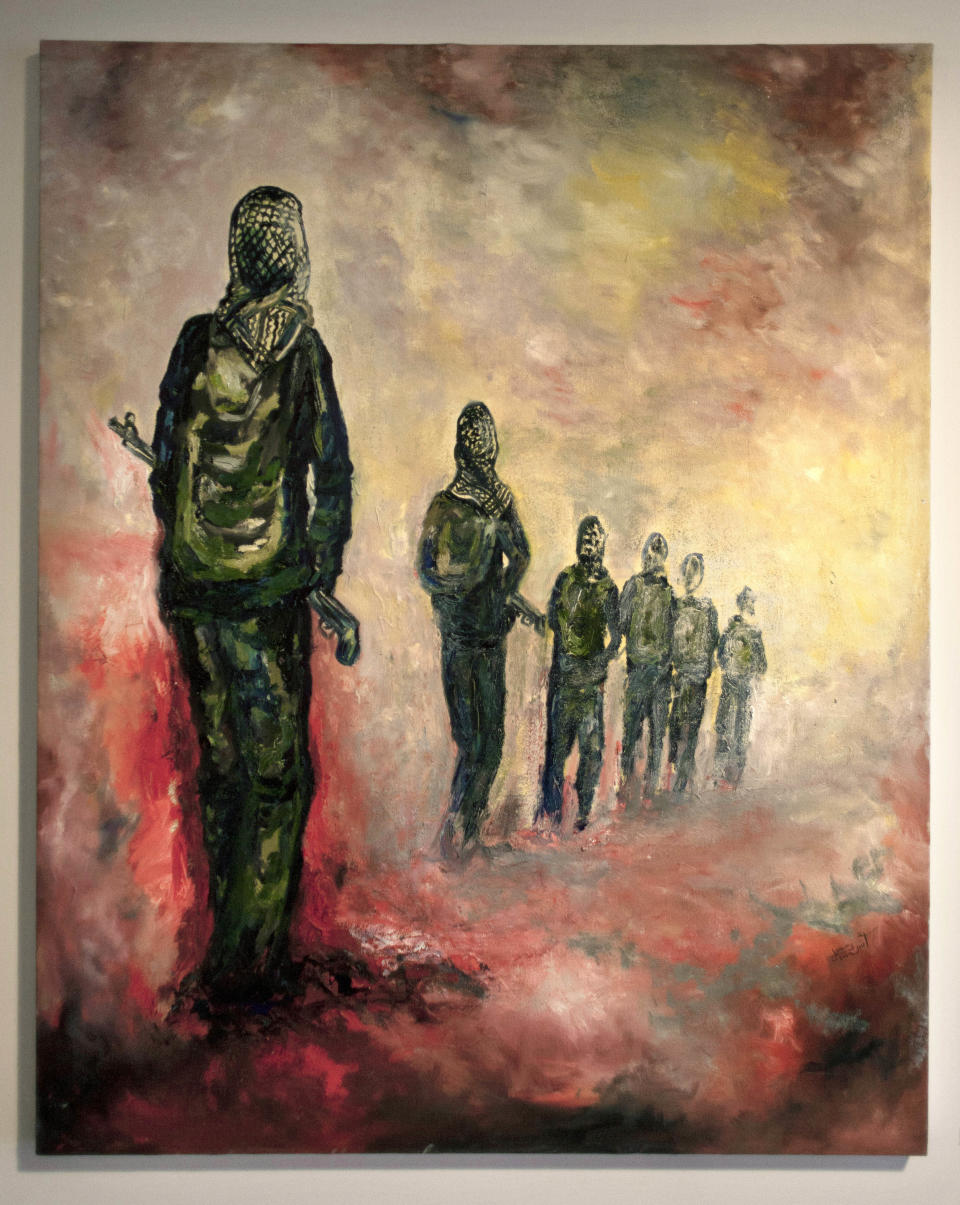 This photo taken Saturday, May 10, 2014, shows an oil on canvas painting by by Palestinian artist Ashraf Sahwiel named Home Land, during an art exhibition "Traces, a testimony to memory," displaying over forty Palestinian artists work from Gaza, in the West Bank city of Ramallah. The Gaza Strip is tough turf for artists. An Israeli-Egyptian border blockade of the Hamas-ruled territory keeps them away from an international audience and potential buyers, while the local art market is close to nil. A new exhibit now offers them a chance to showcase their work outside Gaza. (AP Photo/Nasser Nasser)