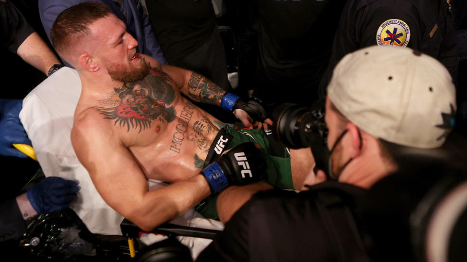 Conor McGregor was carried out of the arena on a stretcher after breaking his ankle in the first round of his lightweight bout against Dustin Poirier at UFC 264. (Photo by Stacy Revere/Getty Images)