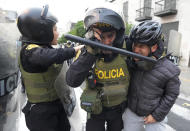 Police detain a protester in support of ousted President Pedro Castillo, during clashes with police in Lima, Peru, Thursday, Dec. 8, 2022. Peru's Congress voted to remove Castillo from office Wednesday and replace him with the vice president, shortly after Castillo tried to dissolve the legislature ahead of a scheduled vote to remove him. (AP Photo/Fernando Vergara)