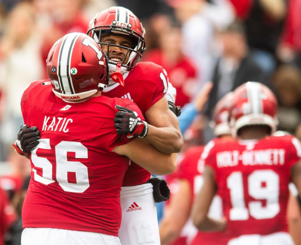 Indiana's Jaylin Lucas (12) celebrates with Mike Katic (56) after Lucas' touchdown during the first half of the Indiana versus Purdue football game at Memorial Stadium on Saturday, Nov. 26, 2022.