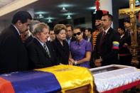 Handout picture released by the Venezuelan presidency showing (from L to R) Venezuela's Vice President Nicolas Maduro, Brazilian former President Lula Da Silva, present Brazilian president Dilma Rousseff, Adan Chavez and Chavez's daughter Rosa Virginia view the body of President Hugo Chavez, in Caracas, on March 7, 2013