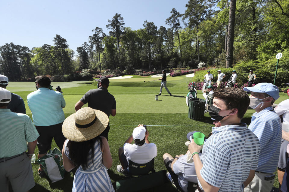 The small gallery of patrons watches Phil Mickelson tee off on the 14th hole during his practice round for the Masters at Augusta National Golf Club on Tuesday, April 6, 2021, in Augusta, Ga. (Curtis Compton/Atlanta Journal-Constitution via AP)