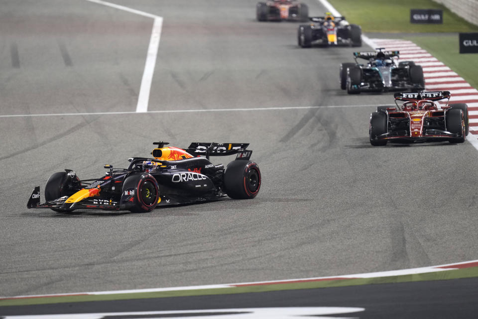 Red Bull driver Max Verstappen of the Netherlands, left, steers his car into a corner at the start of the Formula One Bahrain Grand Prix at the Bahrain International Circuit in Sakhir, Bahrain, Saturday, March 2, 2024. (AP Photo/Darko Bandic)