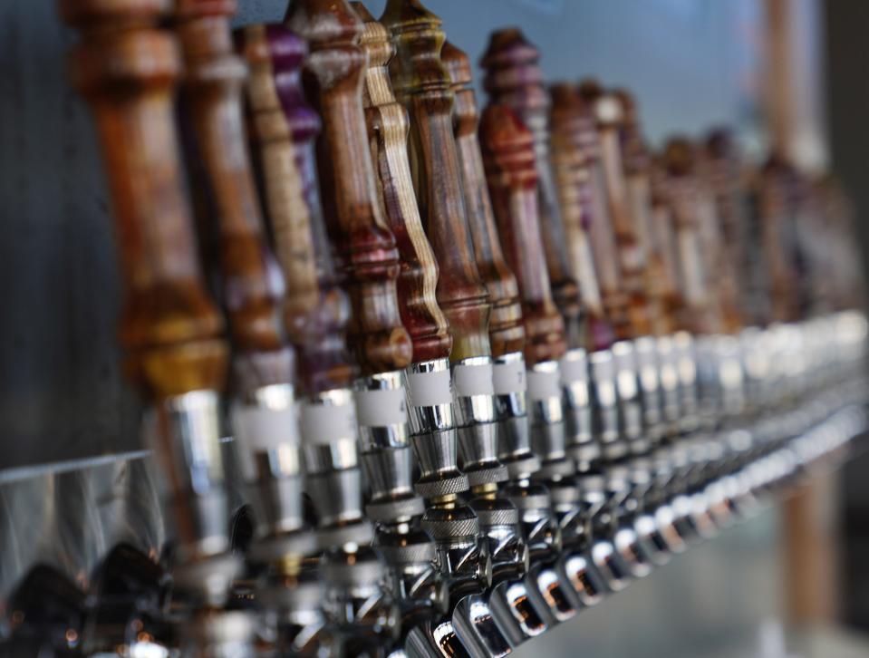 Beer taps inside the Tap Dragon Beer Bar in Gilbert on Jan. 19, 2022.