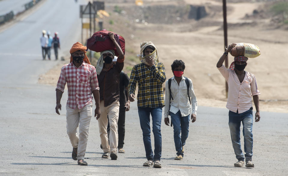 MUMBAI, INDIA - MARCH 30: Migrant workers walk on the Mumbai Nashik highway with their families as they return to their villages, during a 21-day nationwide lockdown to limit the spreading of coronavirus disease (COVID-19), on March 30, 2020 in Mumbai, India.  (Photo by Satyabrata Tripathy/Hindustan Times via Getty Images)