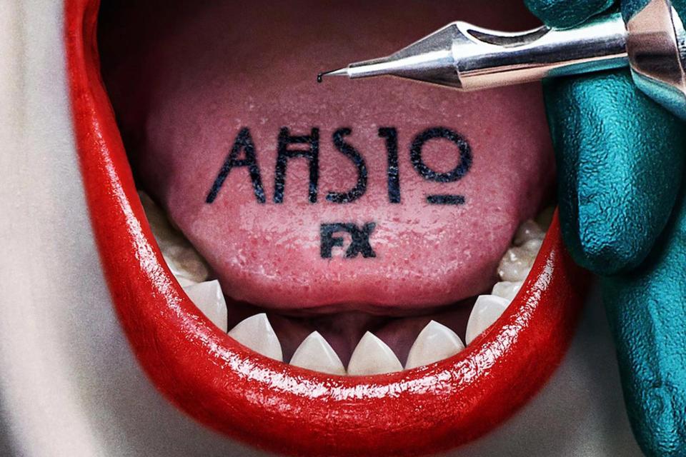 Poster for American Horror Story Season 10 shows the title tattooed on a tongue in a mouth full of pointy teeth.