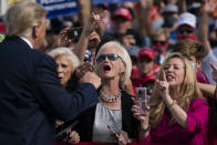 Supporters of President Donald Trump cheer as he walks off stage after speaking at a campaign rally at Pitt-Greenville Airport, Thursday, Oct. 15, 2020, in Greenville, N.C. (AP Photo/Evan Vucci)