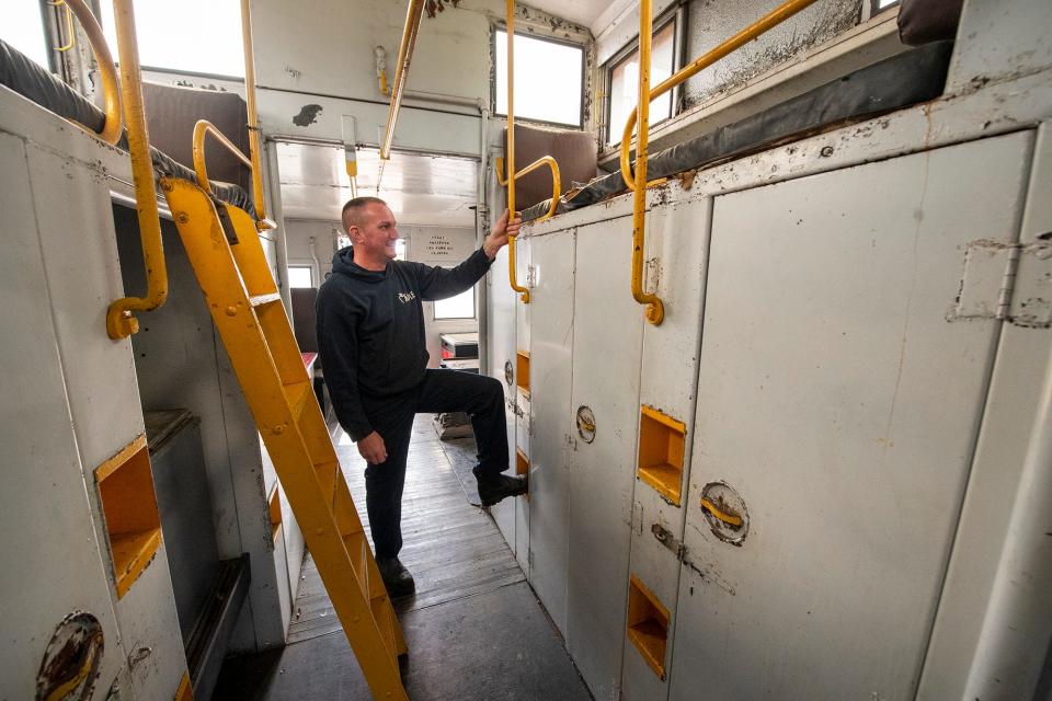 Mark Koppenhaver inside the center of the caboose.