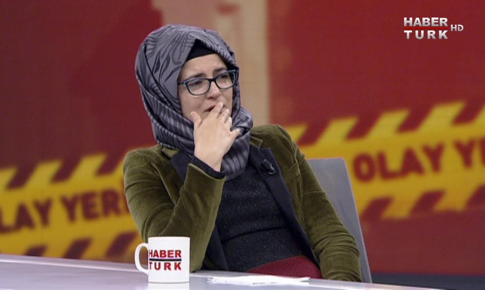 In this image from TV, Hatice Cengiz, who is Turkish, reacts during an interview on Turkish television channel HaberTurk, Friday Oct. 26, 2018, about the day her finacee Saudi writer Jamal Khashoggi entered the Saudi Arabia Consulate on Oct. 2, and was killed inside. Hatice Cengiz said "I found myself in a darkness I cannot express", and talked about when Khashoggi had gone to the consulate for paperwork related to his planned marriage to Cengiz. (HaberTurk TV via AP)