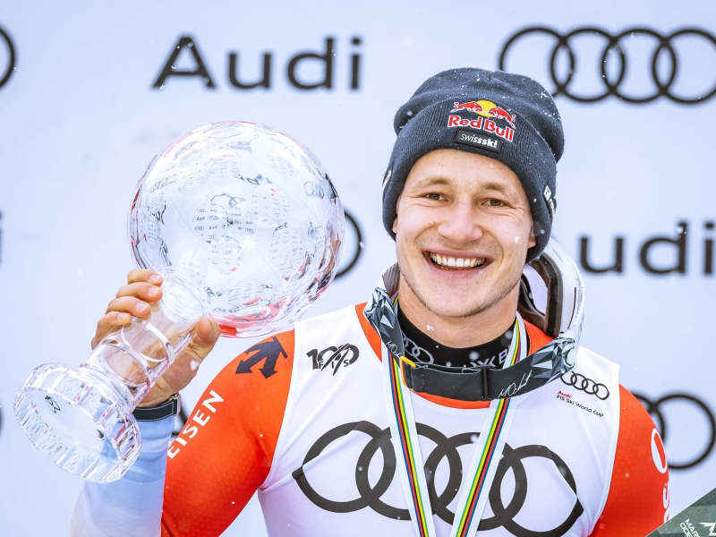 Swiss ski racer Marco Odermatt celebrates with the trophy at the award ceremony of the Men's Overall downhill World Cup. Expa/Johann Groder/APA/dpa