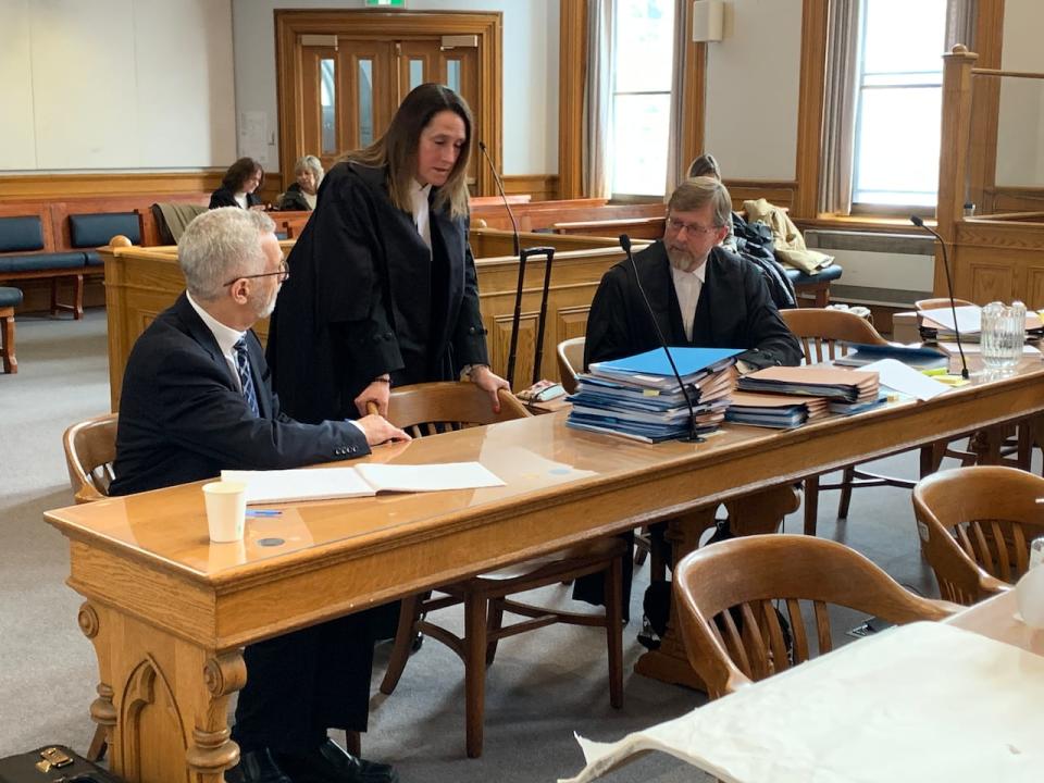 Robert Regular, left, sits with his defence counsel, Rosellen Sullivan and Jerome Kennedy, during a brief recess at Newfoundland and Labrador Supreme Court in St. John's Monday morning.