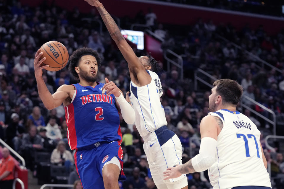 Detroit Pistons guard Cade Cunningham (2) passes during the first half of an NBA basketball game against the Dallas Mavericks, Saturday, March 9, 2024, in Detroit. (AP Photo/Carlos Osorio)