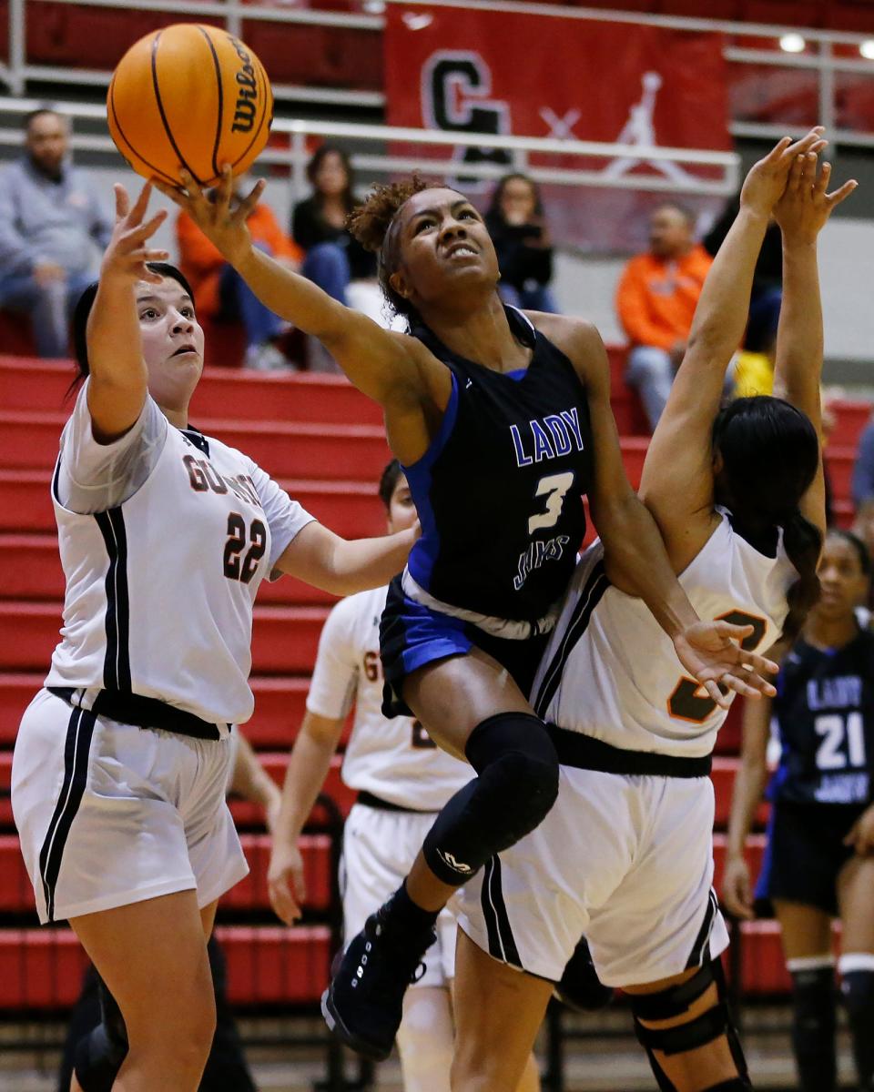 Guthrie's Anjewl Murillo (3) attempts a shot as Guymon's Mercedes Vasquez (22) and Aaliyah Gutierrez (3) defend during a game at Carl Albert in Midwest City on Feb. 26, 2022.