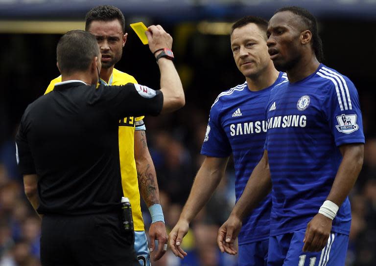 John Terry (2nd right) receives a yellow card during Chelsea's title-winning match against Crystal Palace at Stamford Bridge