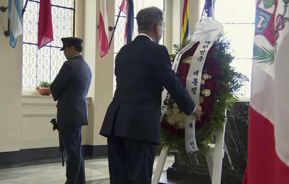 In this image made from a video, South Korean President Moon Jae-in, right, attends a wreath laying ceremony at the Auckland War Memorial Museum in Auckland, New Zealand Monday, Dec. 3, 2018. Moon is on a two-day visit to New Zealand. (TVNZ via AP)