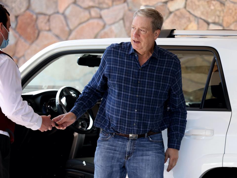 Stanley Druckenmiller exits white SUV at Sun Valley