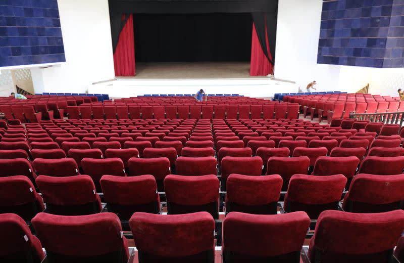 Workers clean seats inside a renovated Somalia's National Theatre in Mogadishu