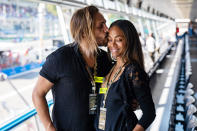 <p>Zoë Saldana and husband Marco Perego cozy up at the Formula One Italian Grand Prix in Monza, Italy, on Sept. 12.</p>
