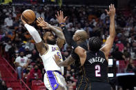 Los Angeles Lakers forward LeBron James (6) attempts to pass the ball as Miami Heat forward P.J. Tucker, center, and guard Gabe Vincent (2) defend during the first half of an NBA basketball game, Sunday, Jan. 23, 2022, in Miami. (AP Photo/Lynne Sladky)