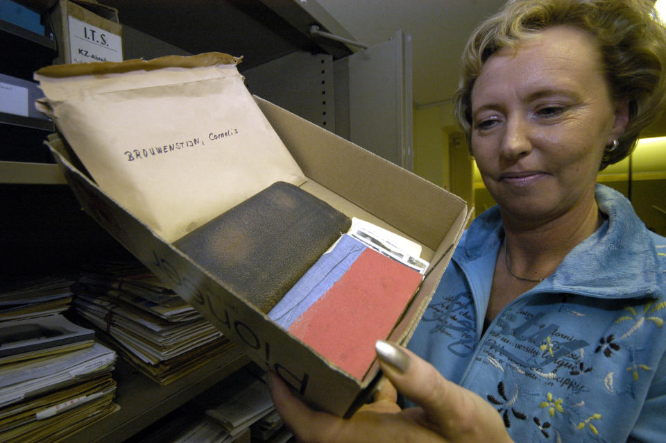 Gabriele Wilke employee of the archive holds a box of the prisoners personal belongings from Neuengamme Concentration Camp near Hamburg at the International Tracing Service in Bad Arolsen, Germany, Friday, Oct. 27, 2006. (AP Photo/Bernd Kammerer)