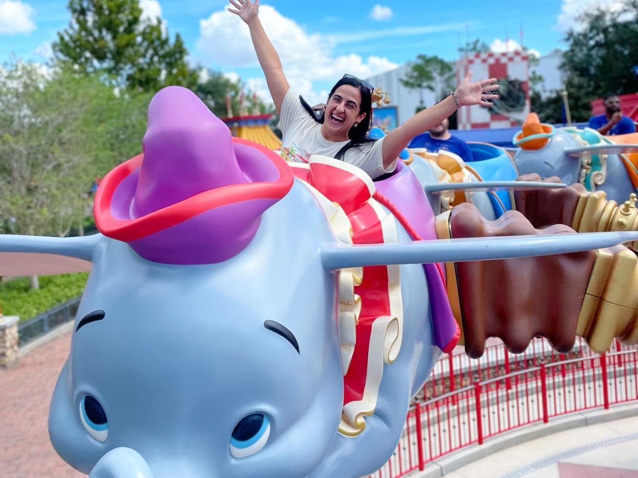 stephanie riding dumbo the flying elephant at disney world