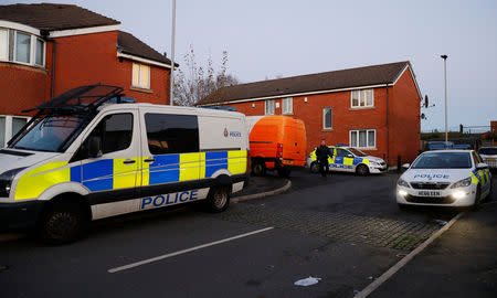 Police vehicles are seen near a house being searched in connection to a stabbing at Victoria Station in Manchester, Britain, January 1, 2019. REUTERS/Phil Noble