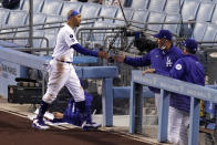 Los Angeles Dodgers' Mookie Betts, left, is congratulated by manager Dave Roberts after scoring on a single by Justin Turner during the first inning of a baseball game against the Colorado Rockies Wednesday, April 14, 2021, in Los Angeles. (AP Photo/Mark J. Terrill)