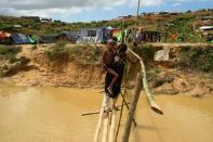 Newer arrivals at the extension of the Kutupalong refugee camp in Bangladesh have had to haul bamboo poles and tarpaulins up steep, muddy slopes and across rivers swollen by the recent monsoon rains