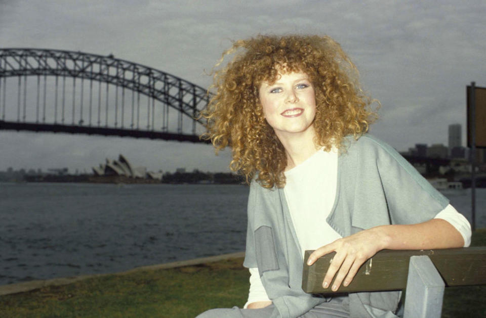 Nicole posing in front of Sydney Harbour, with the Opera House and Harbor Bridge in the background