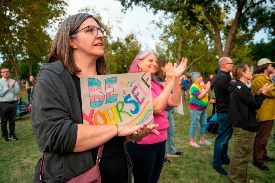 Davis resident and parent, Nada Nakahara, left, stands in unity with others in support of gender-identity topics at the Yolo is for Everyone event Tuesday, Oct. 10, 2023, after recent bomb threats made at Davis-area schools and the city’s main library containing anti-LGBTQ language.