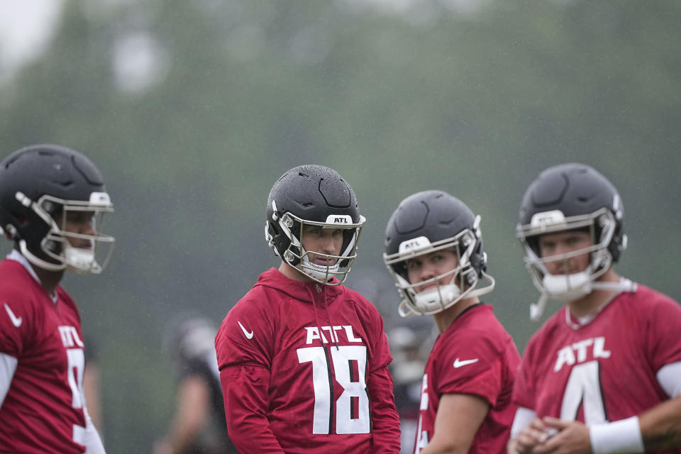 Atlanta Falcons quarterbacks Kirk Cousins, center, and Michael Penix Jr., left, run drills during an NFL football mini training camp practice on Tuesday, May 14, 2024, in Flowery Branch, Ga. (AP Photo/Brynn Anderson)