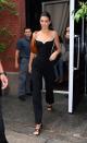 <p>Jenner accessorised her black and white outfit with mules and a brown, structured handbag.</p>