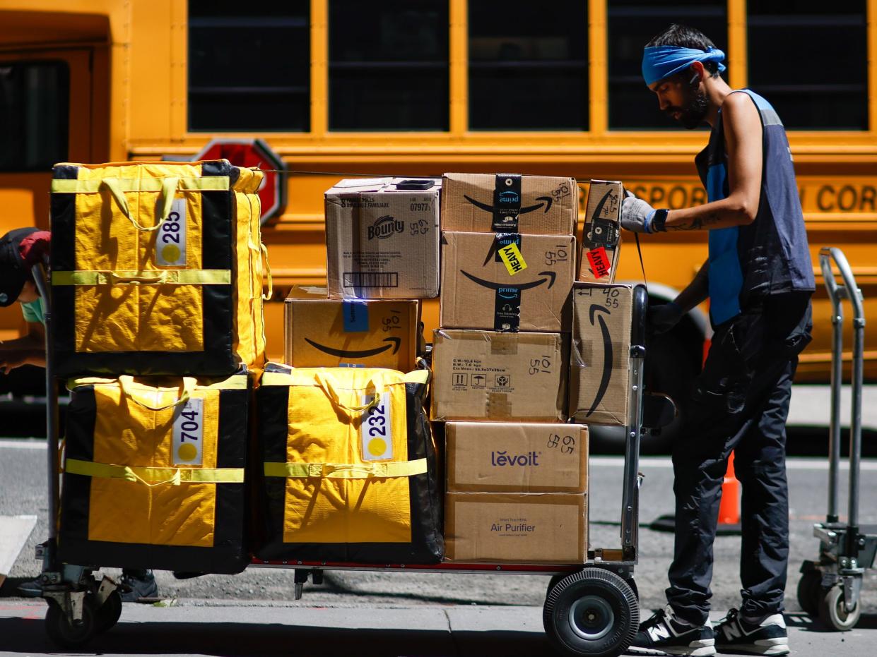 Amazon workers unloading boxes from a truck in Manhattan on July 21, 2023 in New York City.