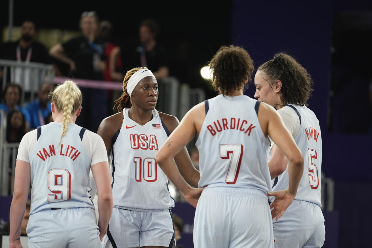 Rhyne Howard of the United States, second left, and teammates react after losing in the women's 3x3 basketball pool round match between the United States and Azerbaijan at the 2024 Summer Olympics, Wednesday, July 31, 2024, in Paris, France. (AP Photo/Rebecca Blackwell)