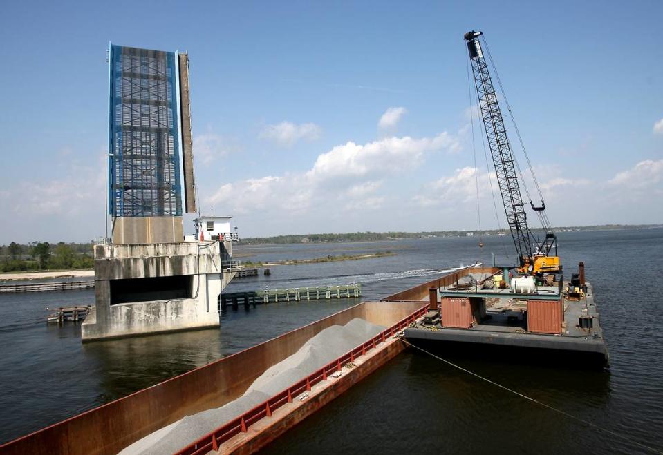 A crane was brought to the Popp’s Ferry Bridge in order to remove the remaining barges on Saturday, March 21 2009. The white structure on the right side of the bridge is the bridge tender’s office.