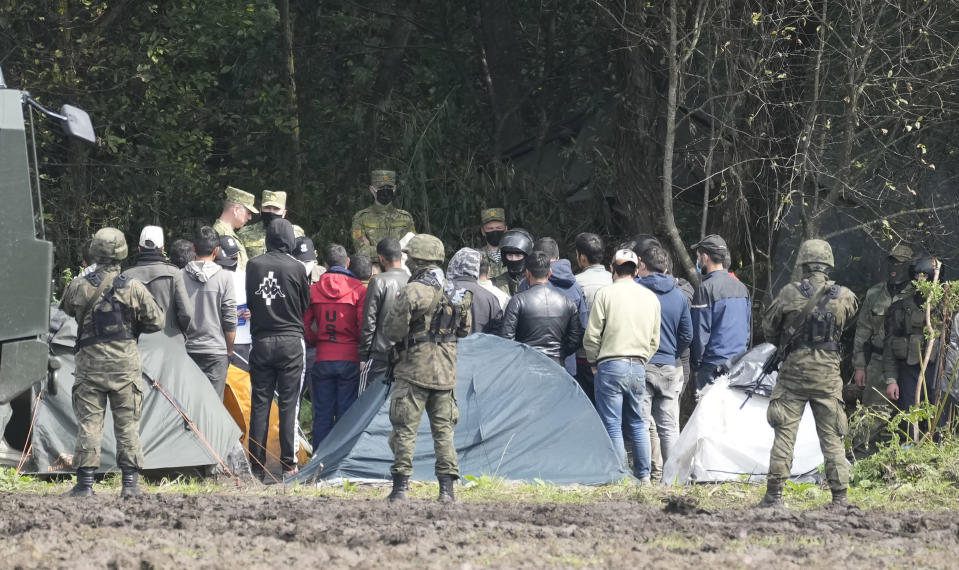 Polish security forces block migrants stuck on the border with Belarus in Usnarz Gorny, Poland, on Wednesday, Sept. 1, 2021. Poland's government said Monday that it is sending 500 additional troops and special vehicles to the border with Belarus to strengthen it against increasing migrant pressure that it says is orchestrated by Belarus and Russia. (AP Photo/Czarek Sokolowski)