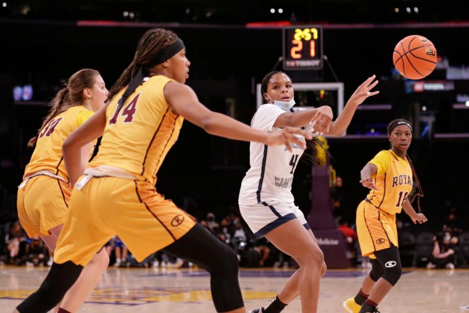 Sierra Canyon's MacKenly Randolph passes under pressure against Christ the King.