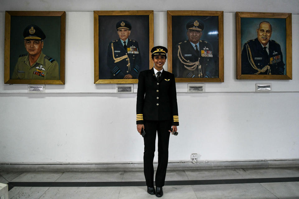 <p>Anny Divya, 31, an Indian pilot who became the youngest woman in the world to captain a Boeing 777 aircraft, poses next to portraits of various air marshals at the Indian Air Force Museum in New Delhi on February 24, 2018. (Photo: Chandan Khanna/AFP/Getty Images) </p>