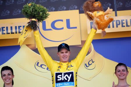 Cycling - Tour de France cycling race - The 162.5 km (101 miles) Stage 11 from Carcassone to Montpellier, France - 13/07/2016 - Yellow jersey leader Team Sky rider Chris Froome of Britain reacts on the podium. REUTERS/Juan Medina