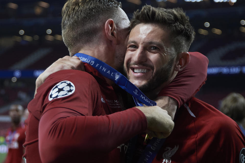 Jordan Henderson and Adam Lallana of Liverpool celebrate after winning the UEFA Champions League Final between Tottenham Hotspur and Liverpool at Estadio Wanda Metropolitano on June 1, 2019 in Madrid, Spain. (Photo by Jose Breton/NurPhoto via Getty Images)