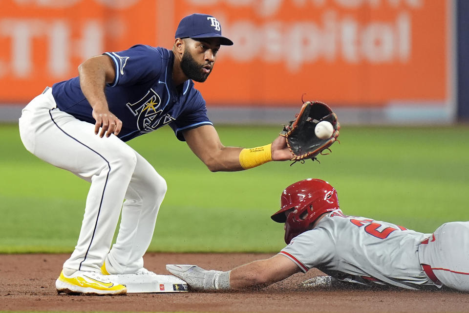 Los Angeles Angels' Mike Trout (27) steals second base ahead of the throw to Tampa Bay Rays' Amed Rosario during the first inning of a baseball game Tuesday, April 16, 2024, in St. Petersburg, Fla. (AP Photo/Chris O'Meara)