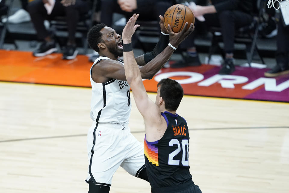 Brooklyn Nets forward Jeff Green (8) drives as Phoenix Suns forward Dario Saric (20) defends during the first half of an NBA basketball game, Tuesday, Feb. 16, 2021, in Phoenix.(AP Photo/Matt York)