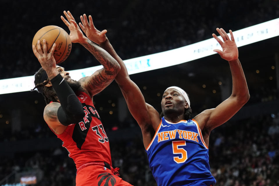 Toronto Raptors guard Gary Trent Jr. (33) is fouled by New York Knicks forward Precious Achiuwa (5) during the first half of an NBA basketball game Wednesday, March 27, 2024, in Toronto. (Frank Gunn/The Canadian Press via AP)