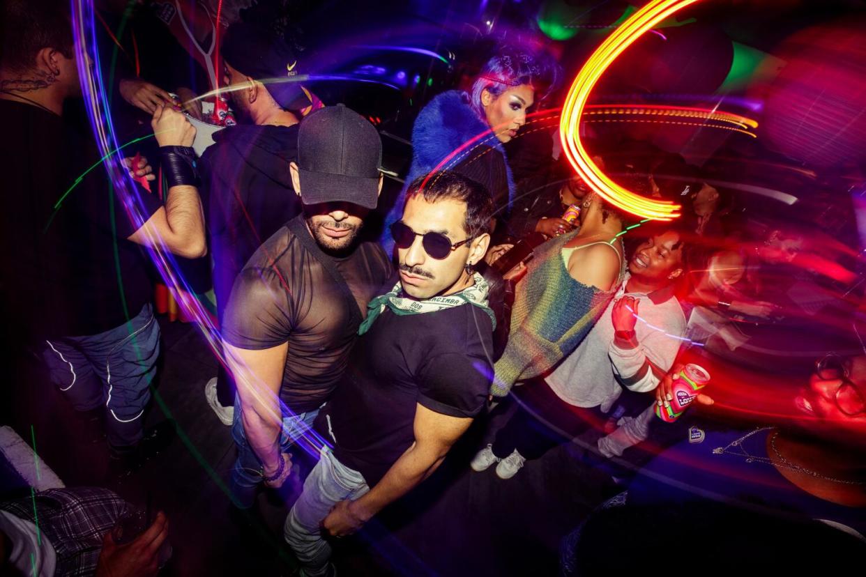 Gay men dancing in a bar in WeHo