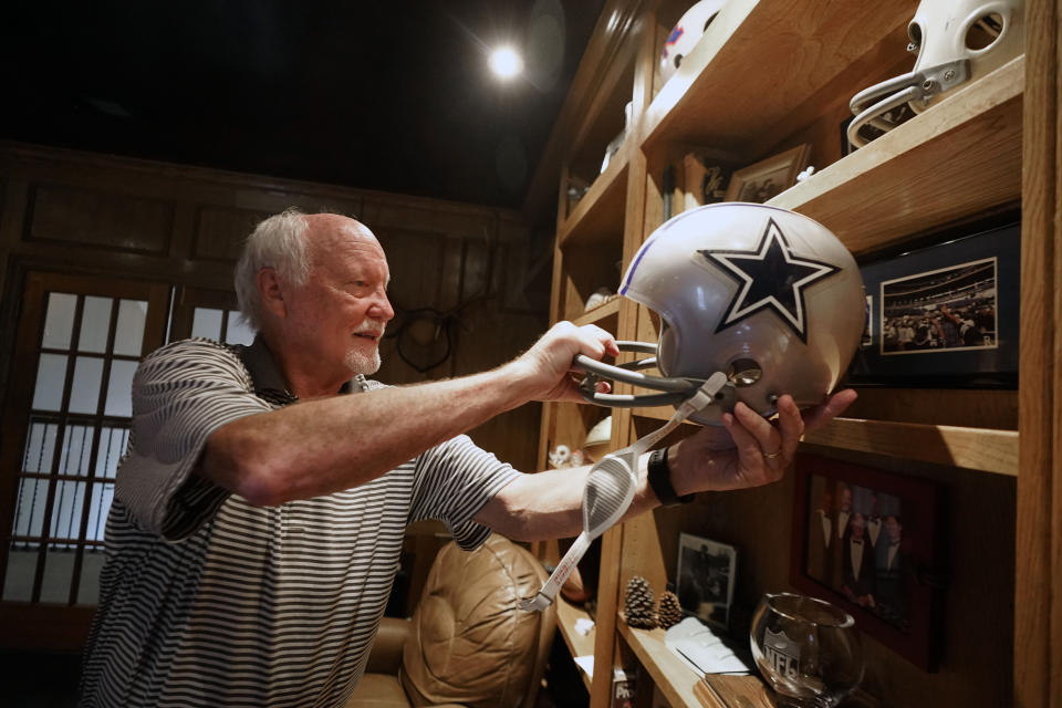 Former Dallas Cowboys and NFL football great Cliff Harris pulls out the helmet he wore during his playing days during an interview at his home in North Dallas, Wednesday, June 30, 2021. Harris and receiver Drew Pearson, who also will be inducted this year as part of the class of 2021, are the first undrafted Cowboys among their 15 players in the Hall of Fame. (AP Photo/LM Otero)